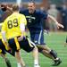 Mark Bihl runs the ball during the Victors Classic alumni football game at Michigan Stadium on Saturday. Melanie Maxwell I AnnArbor.com
